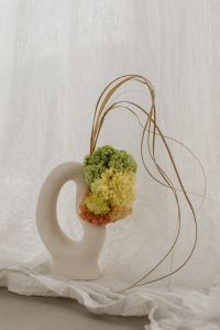 Kaboompics - Sculptural White Vase with Green and Peach Flowers