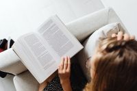 Kaboompics - Overhead View of Girl Reading Textbook in Armchair
