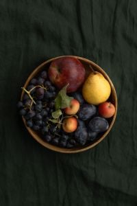 Kaboompics - Autumn Fruit Bowl on Dark Green Fabric With Copy Space