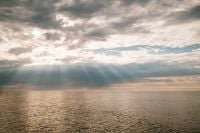 Kaboompics - Sun Rays Breaking Through Clouds Over the Sea