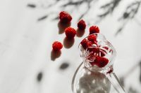 Kaboompics - Raspberries And Tipped Glass In Sunlight