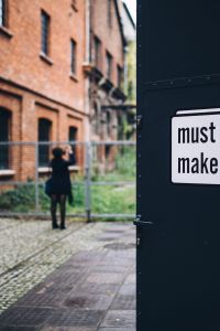 By the entrance to the gallery in the abandoned factory