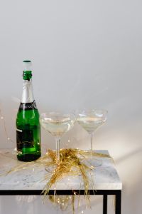 Kaboompics - Champagne Bottle and Two Glasses With Gold Tinsel