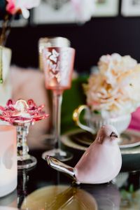 Kaboompics - Pink Ceramic Bird, Floral Teacup and Glass Candle Holder in a Soft Easter Table Still Life