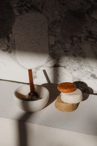 Kaboompics - Ceramic Bowl with Wooden Scoop and Stacked Handmade Soap Bars