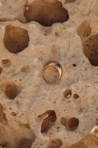 Kaboompics - Gold Ring on Pale Textured Limestone Background
