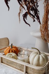 Kaboompics - Wicker Tray with Pumpkins Candle and Dried Flowers