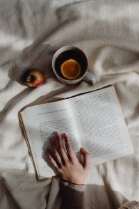 Kaboompics - Open Book and Tea on a Soft Beige Blanket