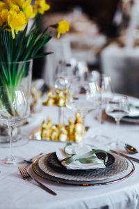 Kaboompics - Table decorations with golden motifs and yellow flowers