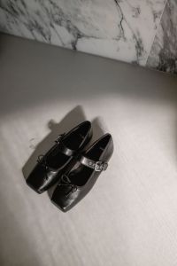 Kaboompics - Black Buckled Mary Jane Shoes on White Shelf
