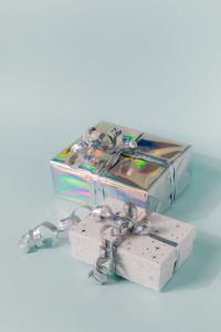 Kaboompics - Stacked Holiday Gifts with Holographic Wrapping