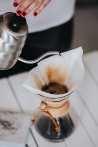Kaboompics - Woman pouring water in Chemex filter coffee maker