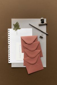 Kaboompics - Pink Dusty Rose Envelopes with Invitation Card and Pen Flatlay