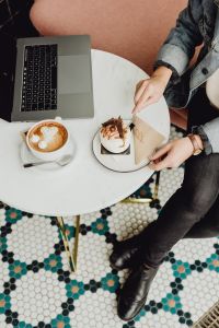 Kaboompics - Working with a laptop, meringue with whipped cream and coffee on white marble