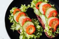 Kaboompics - Vegetable Sandwiches on Black Plate with Lettuce and Tomato