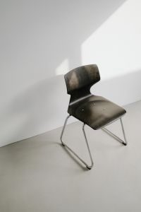 Kaboompics - Close-Up Dark Sculptural Chair with Metal Legs