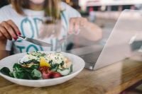 Kaboompics - Close up image of young woman eating classic breakfast at restaurant