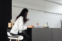 Kaboompics - Woman Enjoying Coffee and Reading in the Kitchen