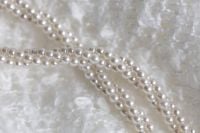 Kaboompics - Pearl Necklace Strands on Textured White Blanket