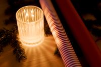 Kaboompics - Candle and Striped Wrapping Paper by Christmas Tree