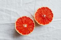 Kaboompics - Two Grapefruit Halves on White Linen for Bright Food Photography