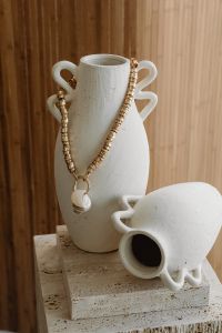 Kaboompics - Gold Necklace on a Ceramic Vase with Coffee Cup