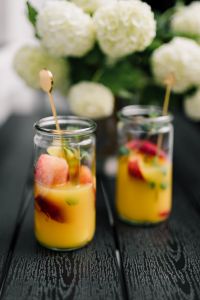 Kaboompics - Two Fruit-Infused Summer Drinks on a Dark Table, Café Menu and Seasonal Beverage Styling