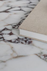 Kaboompics - Linen-Covered Book on a Marble Side Table in a Modern Living Room
