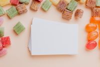 Kaboompics - Gummy Candy Border around Blank White Business Card, Product Mockup Copy Space