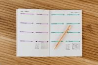 Kaboompics - Color-Coded Weekly Planner Spread on Wooden Desk