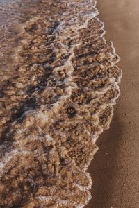 Kaboompics - Foamy Shore Break Curling over Dark Wet Sand