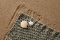 Kaboompics - Seashells on a Gray Knit Fabric Over Sand