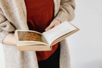 Kaboompics - Close View of Illustrated Book Pages in a Woman’s Hands for Literary Social Media