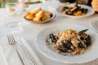 Kaboompics - Seafood Risotto with Mussels and Cutlery at Dining Table