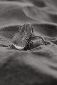 Kaboompics - Monochrome Silver Ring on Textured Sand, Minimal Jewelry Photo