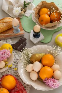 Kaboompics - Easter Table Styling with Ceramic Egg Cups, Baguette and Oranges