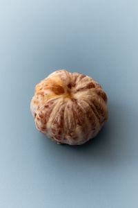 Kaboompics - Pink Grapefruit Half on Blue Background