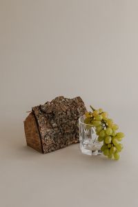 Kaboompics - Bark, White Mushroom and Green Grapes on Neutral Surface