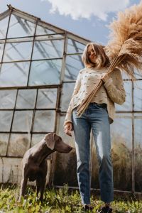 Kaboompics - Woman Carrying Pampas Grass Beside a Weimaraner at a Greenhouse