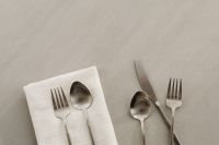 Kaboompics - Scattered Stainless Steel Spoon, Knife and Fork on Neutral Background