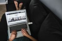Kaboompics - Rear view of woman using laptop on sofa in the living room