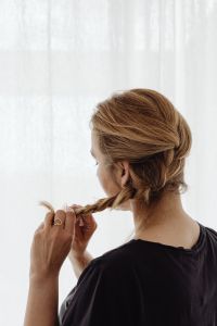 Kaboompics - Woman Braiding a French Braid Over Her Shoulder