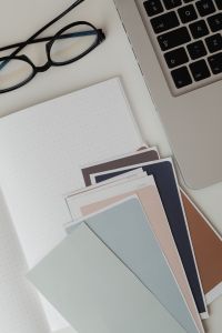 Kaboompics - Pastel Paint Swatches on Notebook Beside Laptop