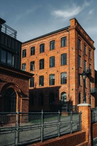 Kaboompics - Sunlit Brick Loft Facade with Black Window Frames