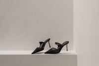 Kaboompics - Black Pointed Heels on White Display Shelf