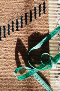 Measuring Fabric for Sewing and Textile Projects with a Green Tape Measure