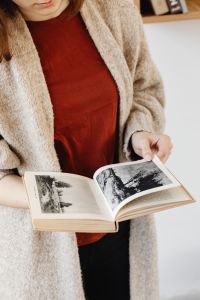 Kaboompics - Young Woman in a Wool Sweater Reading an Illustrated Book for Lifestyle Editorials