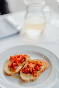 Kaboompics - Soft Focus Tomato Bruschetta with Wine Glass Background
