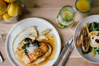 Kaboompics - Healthy Dinner Spread with Salmon, Warm Goat Cheese Salad, Lemonade and Fresh Fruit