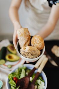 Kaboompics - Bowl of Bread Rolls on Kitchen Table with Fresh Salad Ingredients